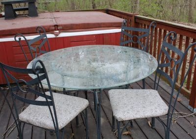 42" diameter glass top with wrought iron, 4 chairs with vinyl seating for sale