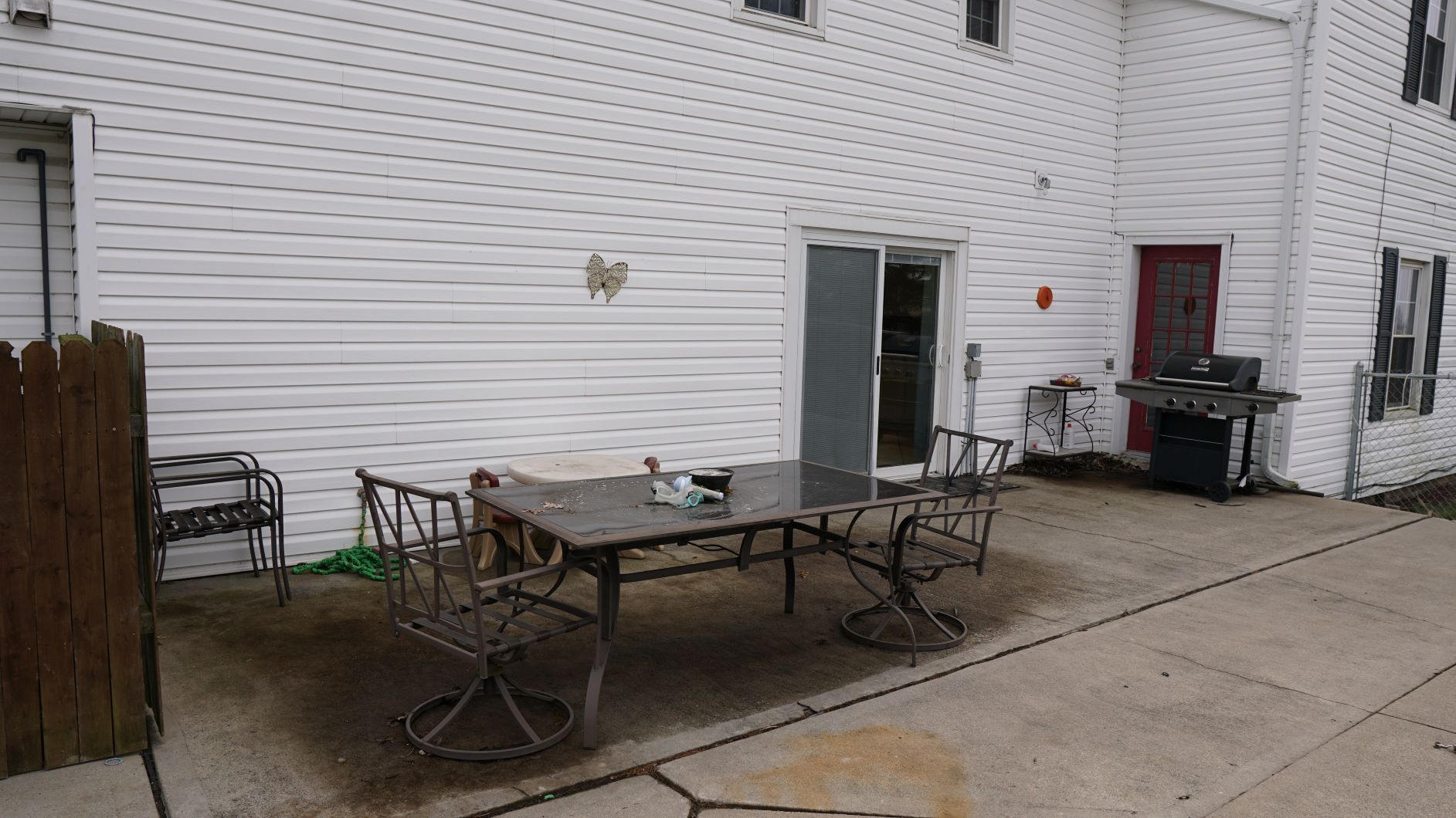 Patio area is enclosed in fence area with pool
